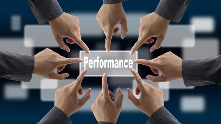 Várias mãos apontando para a palavra “Performance”, representando foco coletivo em como liderar uma equipe com alta performance.